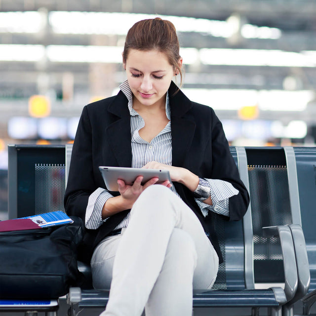 Young girl sat in airport waiting room